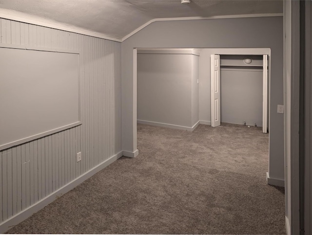 interior space with vaulted ceiling and carpet