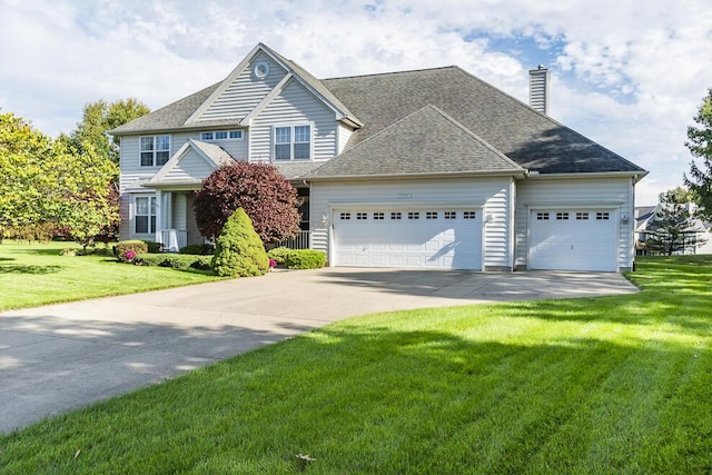 view of front of house featuring a garage, driveway, roof with shingles, a front lawn, and a chimney