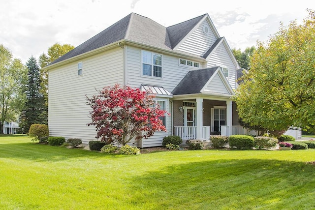 view of side of property with a shingled roof, a porch, and a lawn