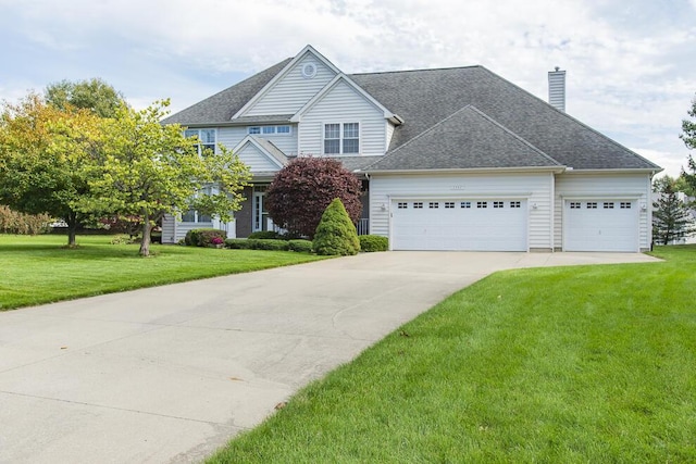 view of front of house with concrete driveway, a chimney, roof with shingles, an attached garage, and a front lawn