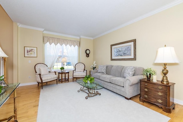 living room with light wood-style flooring, ornamental molding, and baseboards