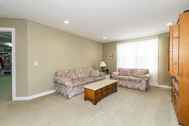 living area featuring recessed lighting, baseboards, and light colored carpet