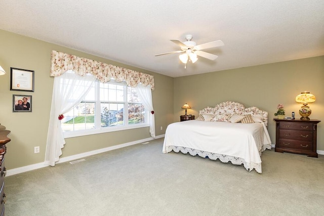 bedroom featuring visible vents, carpet flooring, a ceiling fan, and baseboards