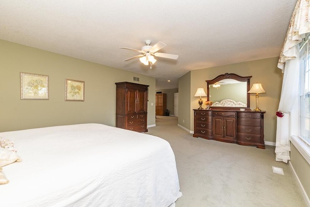 bedroom with light colored carpet, visible vents, baseboards, and multiple windows