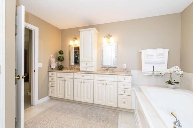 bathroom featuring double vanity, a sink, a bath, and tile patterned floors