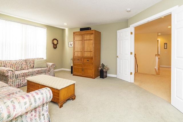 living room featuring light carpet, baseboards, and recessed lighting