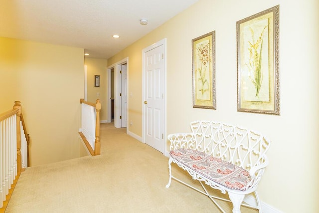 hall featuring carpet floors, recessed lighting, an upstairs landing, and baseboards