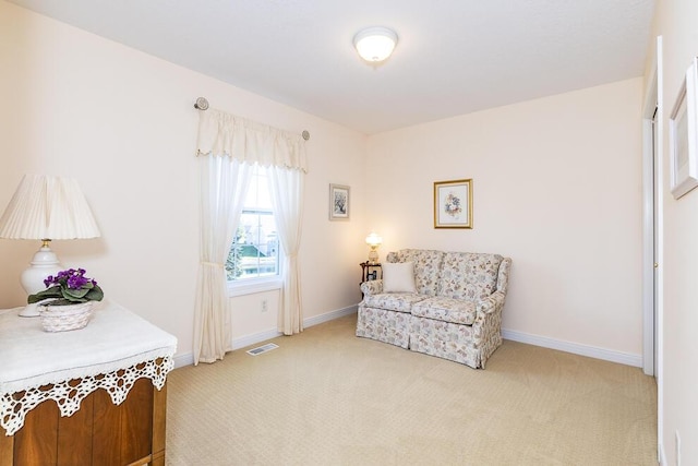 sitting room with light carpet, baseboards, and visible vents