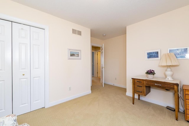 bedroom with light carpet, baseboards, visible vents, and a closet