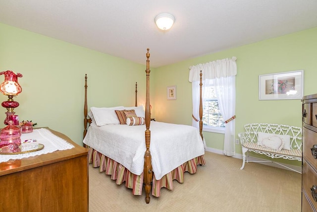 bedroom with light carpet and baseboards