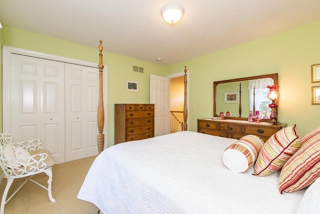 carpeted bedroom featuring a closet and visible vents