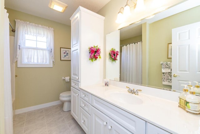 bathroom featuring toilet, vanity, a shower with curtain, baseboards, and tile patterned floors