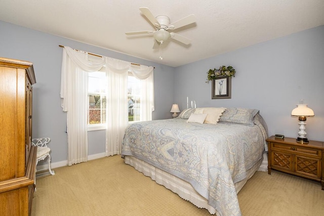 bedroom with carpet floors, ceiling fan, and baseboards