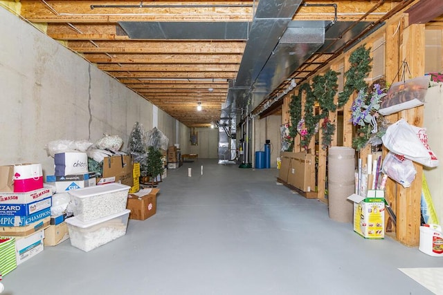 unfinished basement featuring heating unit