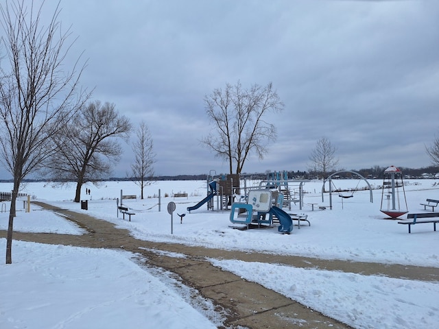 yard covered in snow with playground community