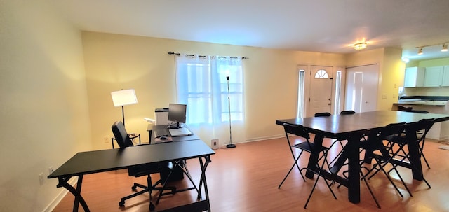 dining room featuring light wood-type flooring and baseboards