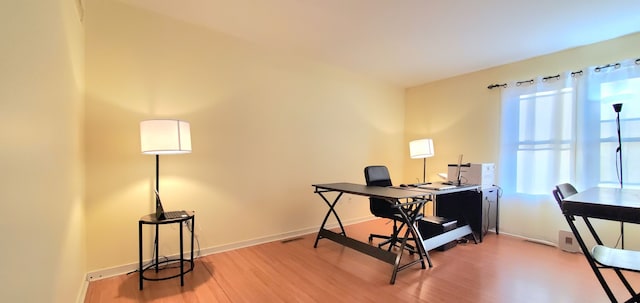 office space with light wood-style floors and baseboards