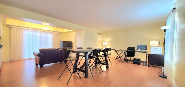 dining room with visible vents, baseboards, and light wood finished floors