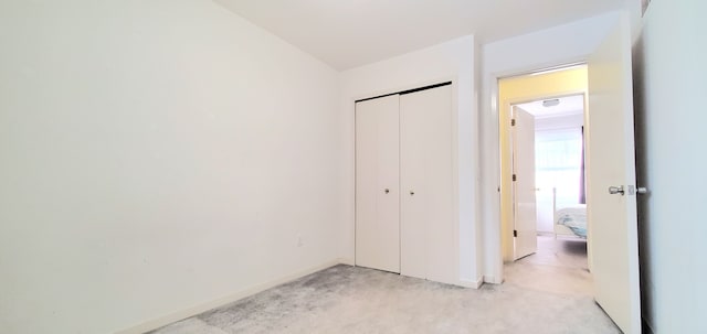 unfurnished bedroom with baseboards, a closet, and concrete floors