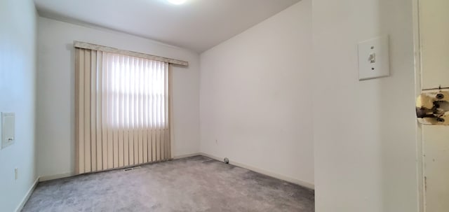 unfurnished room featuring baseboards and carpet floors