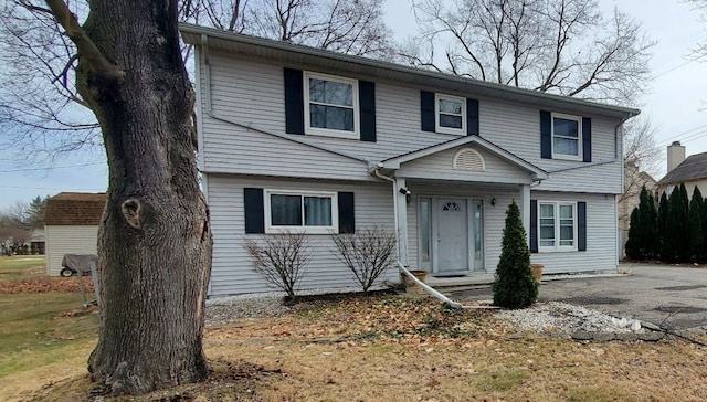 colonial inspired home with driveway