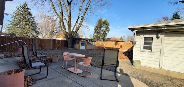 view of patio / terrace with an outdoor structure and a fenced backyard