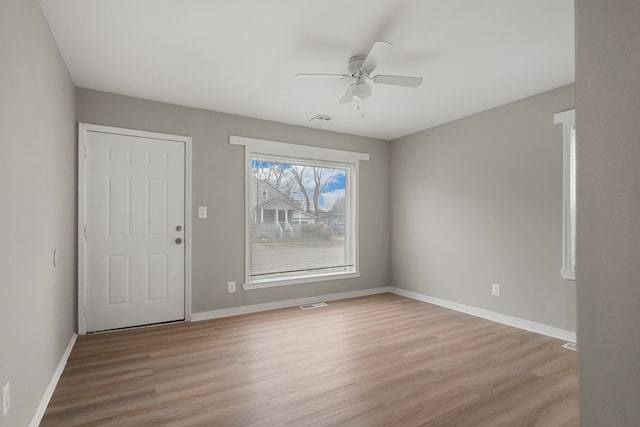 entryway with light wood-type flooring, baseboards, and visible vents