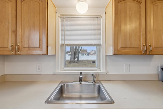 kitchen featuring light countertops and a sink