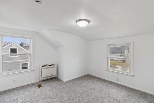 bonus room featuring heating unit, light colored carpet, a wealth of natural light, and lofted ceiling