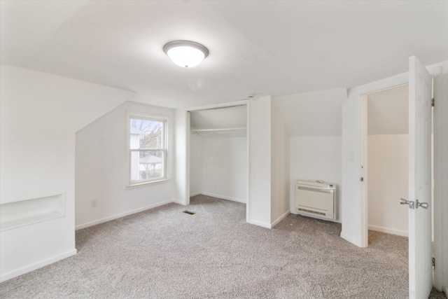 bonus room with vaulted ceiling, carpet, baseboards, and heating unit