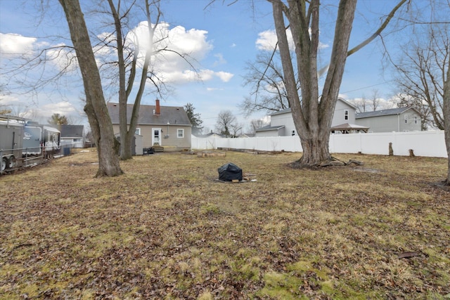 view of yard featuring entry steps and fence