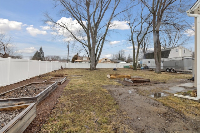 view of yard featuring a vegetable garden and fence