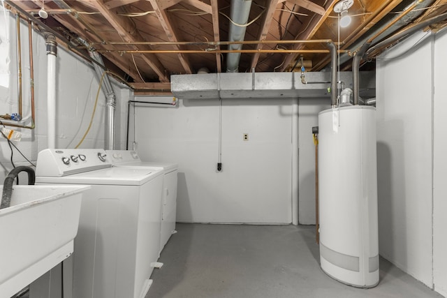 clothes washing area featuring washer and dryer, laundry area, water heater, and a sink