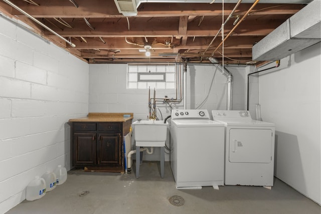 laundry area featuring laundry area, visible vents, a sink, and washing machine and clothes dryer