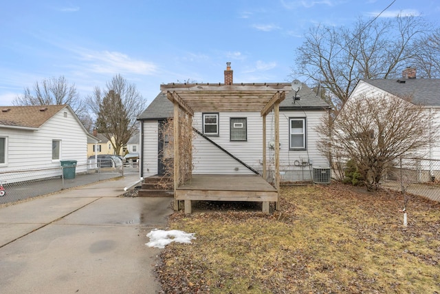 back of property featuring a chimney, fence, a wooden deck, central air condition unit, and a pergola