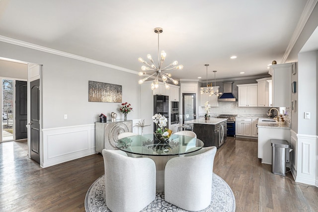 dining space with recessed lighting, a wainscoted wall, dark wood-style floors, an inviting chandelier, and crown molding