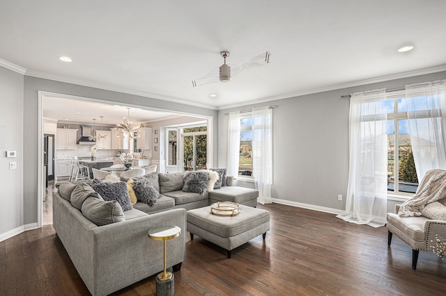 living area with baseboards, dark wood finished floors, a wealth of natural light, and crown molding