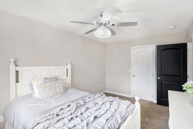 carpeted bedroom with ceiling fan and baseboards