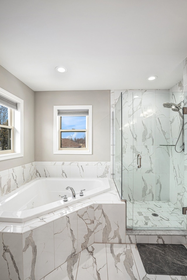 full bath featuring a garden tub, a marble finish shower, and recessed lighting