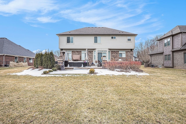 back of house with a patio area, brick siding, an outdoor living space, and a yard