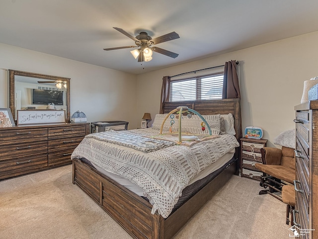 bedroom with light carpet and a ceiling fan