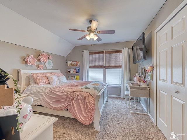 bedroom with light carpet, vaulted ceiling, baseboards, and ceiling fan