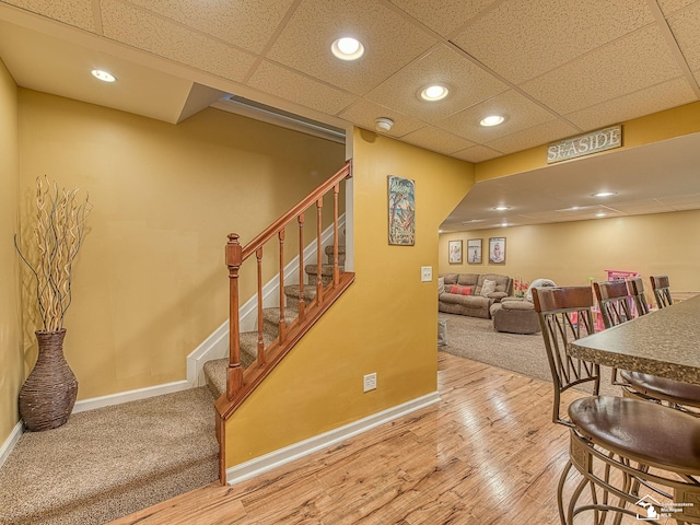 dining room with stairs, recessed lighting, wood finished floors, and baseboards