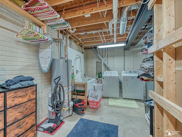 unfinished below grade area featuring washer and clothes dryer and gas water heater