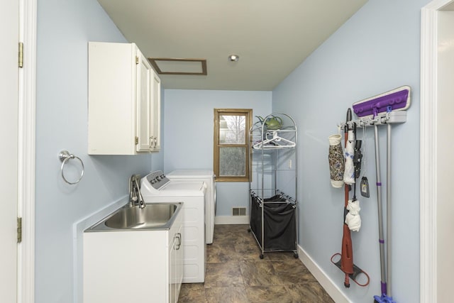 1085 Melrose Ct, Saline, MI 48176 - laundry room with a sink, baseboards, stone finish floor, cabinet space, and washer and dryer
