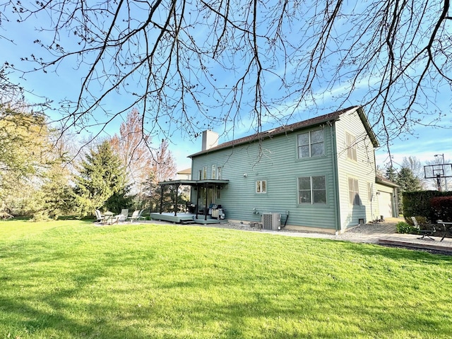 1085 Melrose Ct, Saline, MI 48176 - rear view of house with a patio area, a lawn, a chimney, and central AC