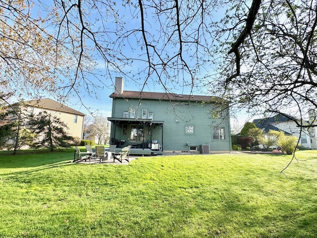 1085 Melrose Ct, Saline, MI 48176 - rear view of house with a chimney, central AC unit, a yard, and a patio