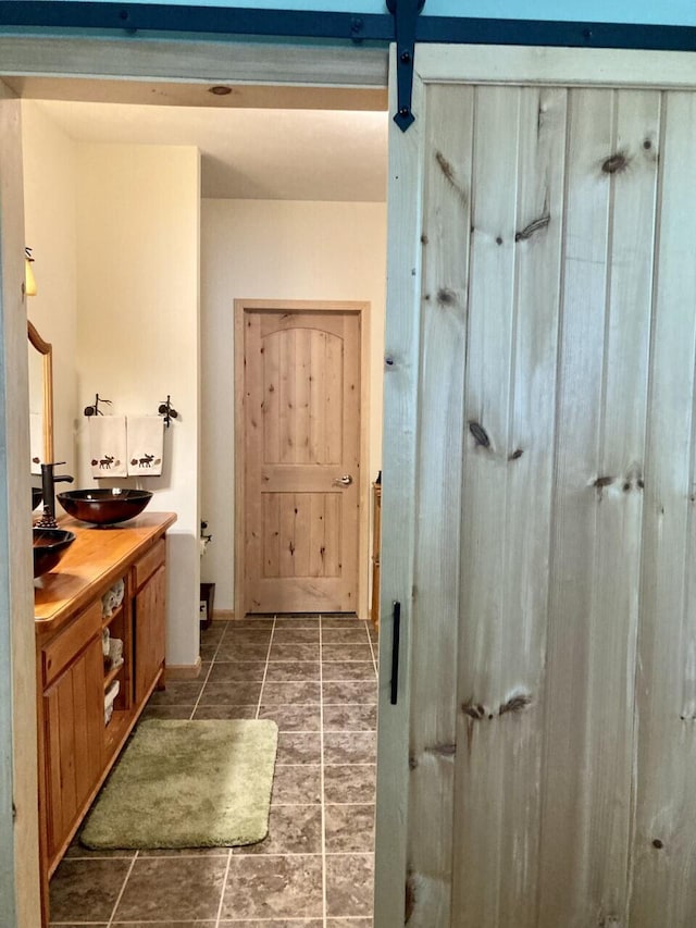 bathroom featuring a sink and double vanity