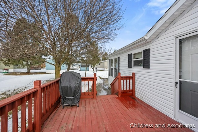 snow covered deck featuring area for grilling