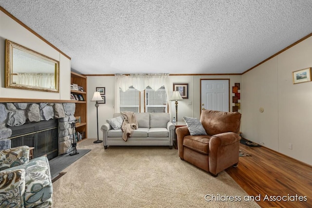 living area featuring a textured ceiling, a fireplace, crown molding, and wood finished floors